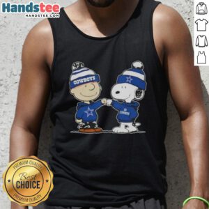 Charlie Brown fist bumps Snoopy in a Dallas Cowboys football tank top, showcasing Nice Peanuts fan apparel.