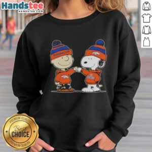 Charlie Brown and Snoopy fist bump in Denver Broncos sweatshirt, celebrating friendship and football spirit.