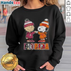 Official Charlie Brown fist bump sweatshirt featuring Snoopy, perfect for Florida City sports fans and Seminoles/Buccaneers supporters.