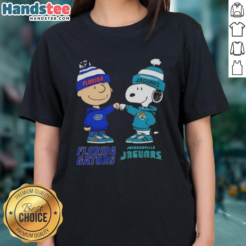 Official Charlie Brown fist bump with Snoopy on a Florida Gators x Jacksonville Jaguars ladies tee design.