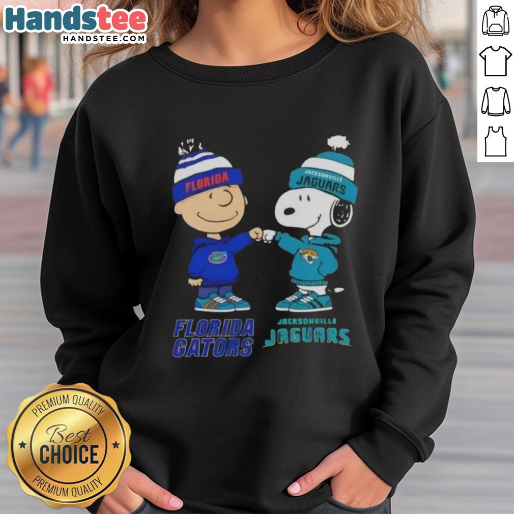 Official Charlie Brown fist bump with Snoopy on Florida Gators x Jacksonville Jaguars sweatshirt, perfect for fans.