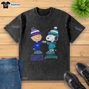 Alt Text: Official Charlie Brown fist bump with Snoopy on a Florida Gators x Jacksonville Jaguars washed t-shirt.