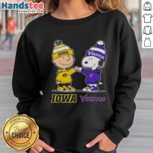Official Charlie Brown fist bump with Snoopy on Iowa Hawkeyes x Minnesota Vikings sweatshirt design.