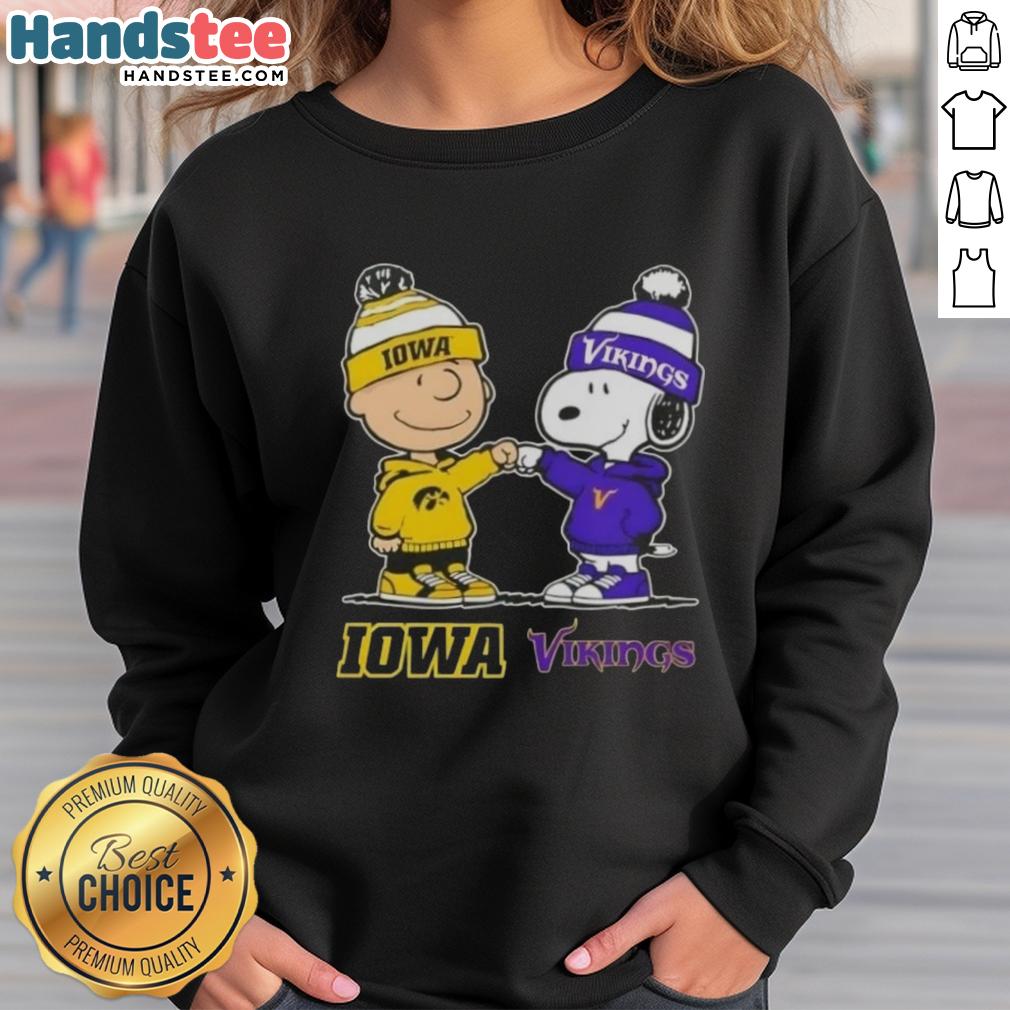 Official Charlie Brown fist bump with Snoopy on Iowa Hawkeyes x Minnesota Vikings sweatshirt design.