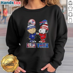 Official Charlie Brown fist bump with Snoopy, NYC skyline, featuring Yankees and Buffalo Bills on a stylish sweatshirt.