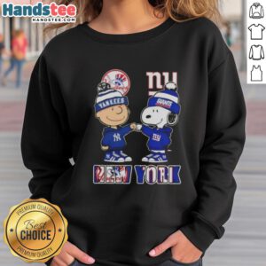 Official Charlie Brown fist bump with Snoopy on NYC skyline sweatshirt, featuring Yankees and Giants sports themes.