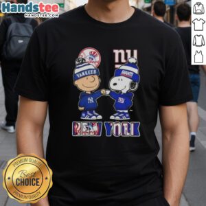 Official Charlie Brown fist bump with Snoopy NYC skyline, showcasing Yankees and Giants sports on a trendy t-shirt.