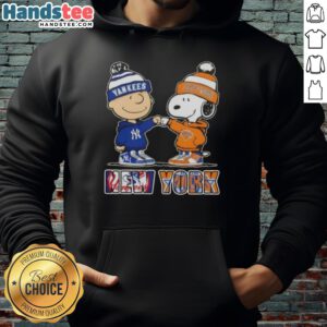 Alt Text: Official Charlie Brown fist bump with Snoopy on a New York City sports hoodie featuring Yankees and Knicks logos.