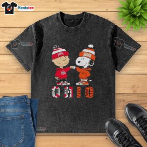 Official Charlie Brown fist bump with Snoopy on Ohio City sports Buckeyes X Cleveland Browns washed t-shirt design.