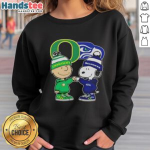 Official Charlie Brown fist bump with Snoopy on Oregon Ducks x Seattle Seahawks sweatshirt, perfect for fans.