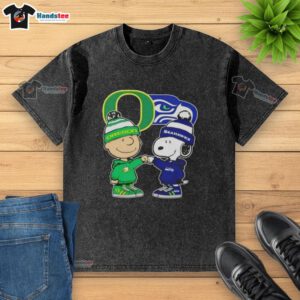 Official Charlie Brown fist bump with Snoopy on Oregon Ducks x Seattle Seahawks washed t-shirt, perfect for fans.