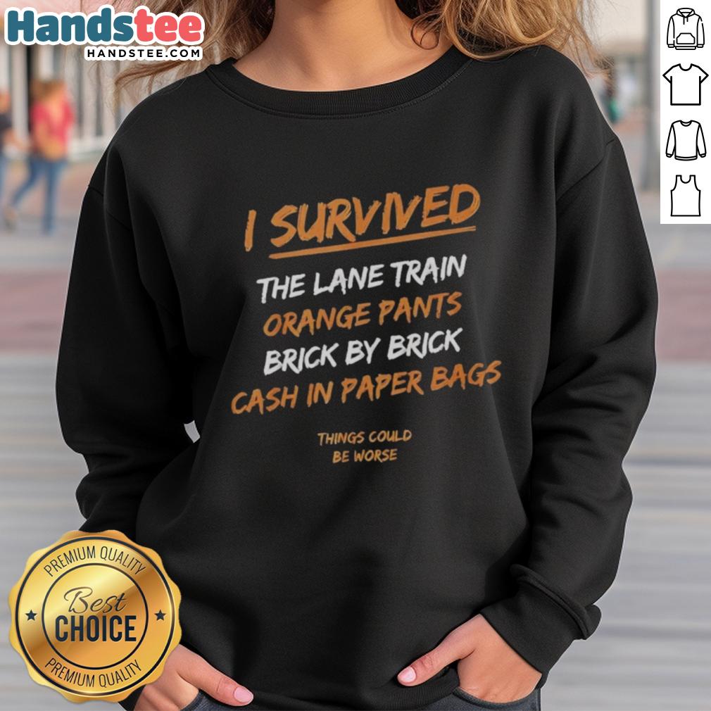 Official I Survived The Lane Train sweatshirt in orange pants, featuring a brick-by-brick cash-in design.