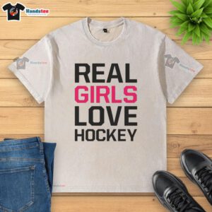 Official Real Girls Love Hockey washed t-shirt in soft fabric, featuring a stylish hockey-themed graphic for fans.