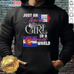 Cozy 'Good Just An Iowa Girl In A Colorado World' hoodie worn by a smiling woman in a scenic Colorado landscape.