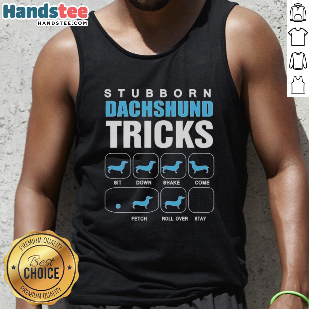 Nice stubborn Dachshund wearing a tank top showcasing fun tricks in a sunny backyard setting.