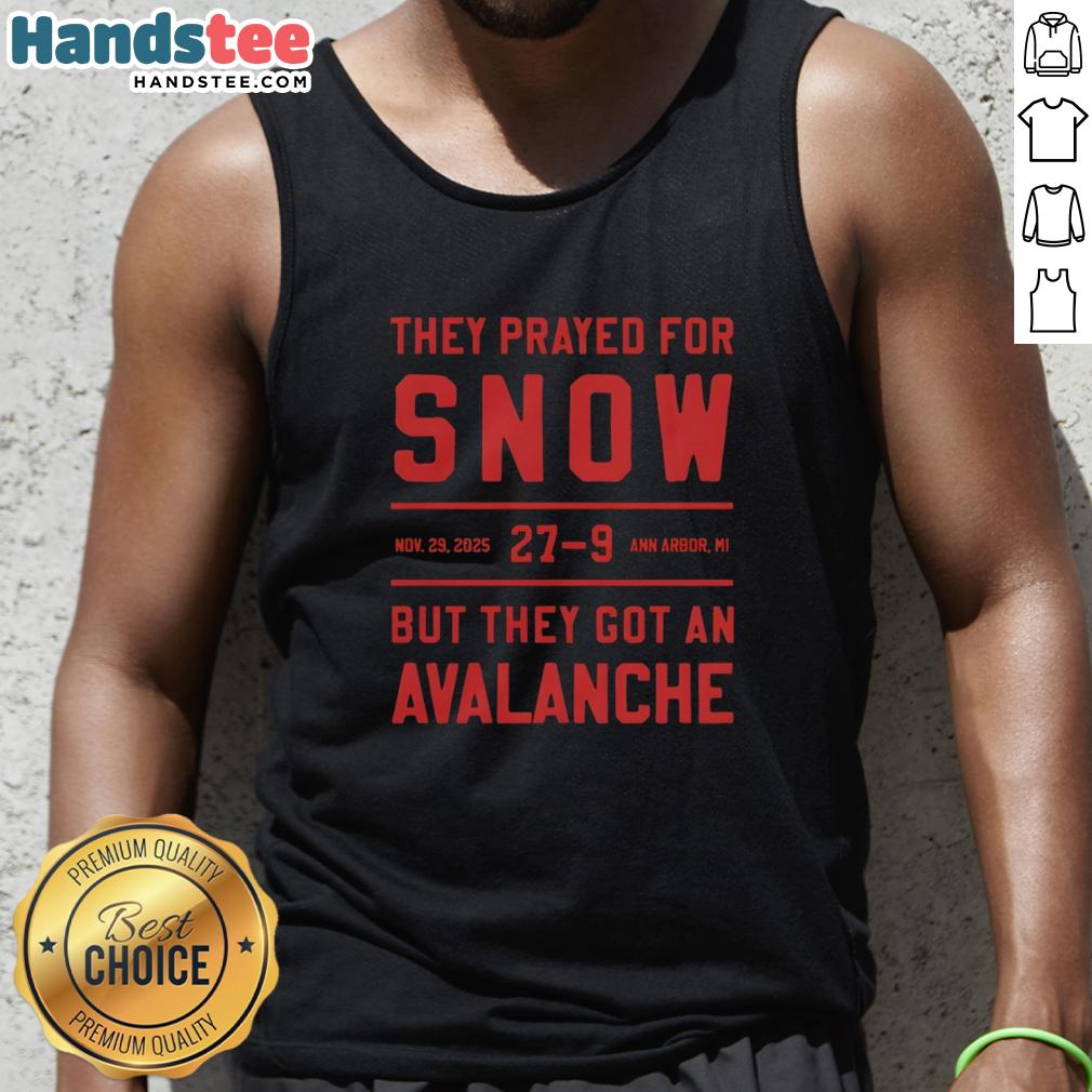 People in Ann Arbor, MI, wearing 'Nice They Prayed For Snow' tank tops during an unexpected avalanche on Nov 29, 2025.