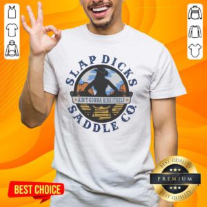 Alt Text: Official Ain't Gonna Ride Itself Slap Dicks Saddle Co Logo T-Shirt featuring a bold logo design and vibrant colors.