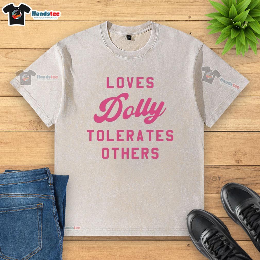Alt Text: Official Loves Dolly Tolerates Others washed t-shirt featuring a fun graphic design on a casual, stylish shirt.