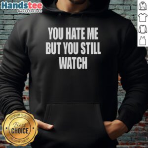 Alt Text: Official You Hate Me But You Still Watch Hoodie in black, featuring bold white text and a casual streetwear design.