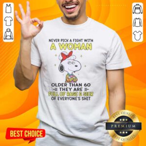 Alt Text: Nice Peanuts Snoopy t-shirt design: 'Never Pick A Fight With A Woman Older Than 60' with cartoon graphics.