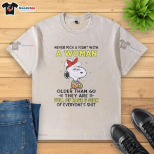 Alt Text: Nice Peanuts Snoopy shirt featuring the quote about women over 60, highlighting humor and style in a washed t-shirt.