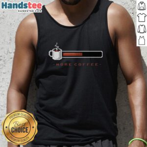 Stylish woman wearing a 'More Coffee' tank top at a trendy coffee bar, showcasing coffee culture and fashion.