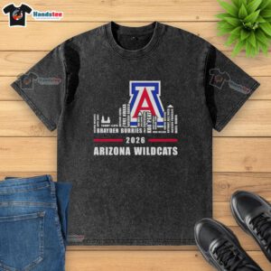 Alt Text: Top 2026 Arizona Wildcats logo with city skyline design on a washed t-shirt, perfect for fans and collectors.