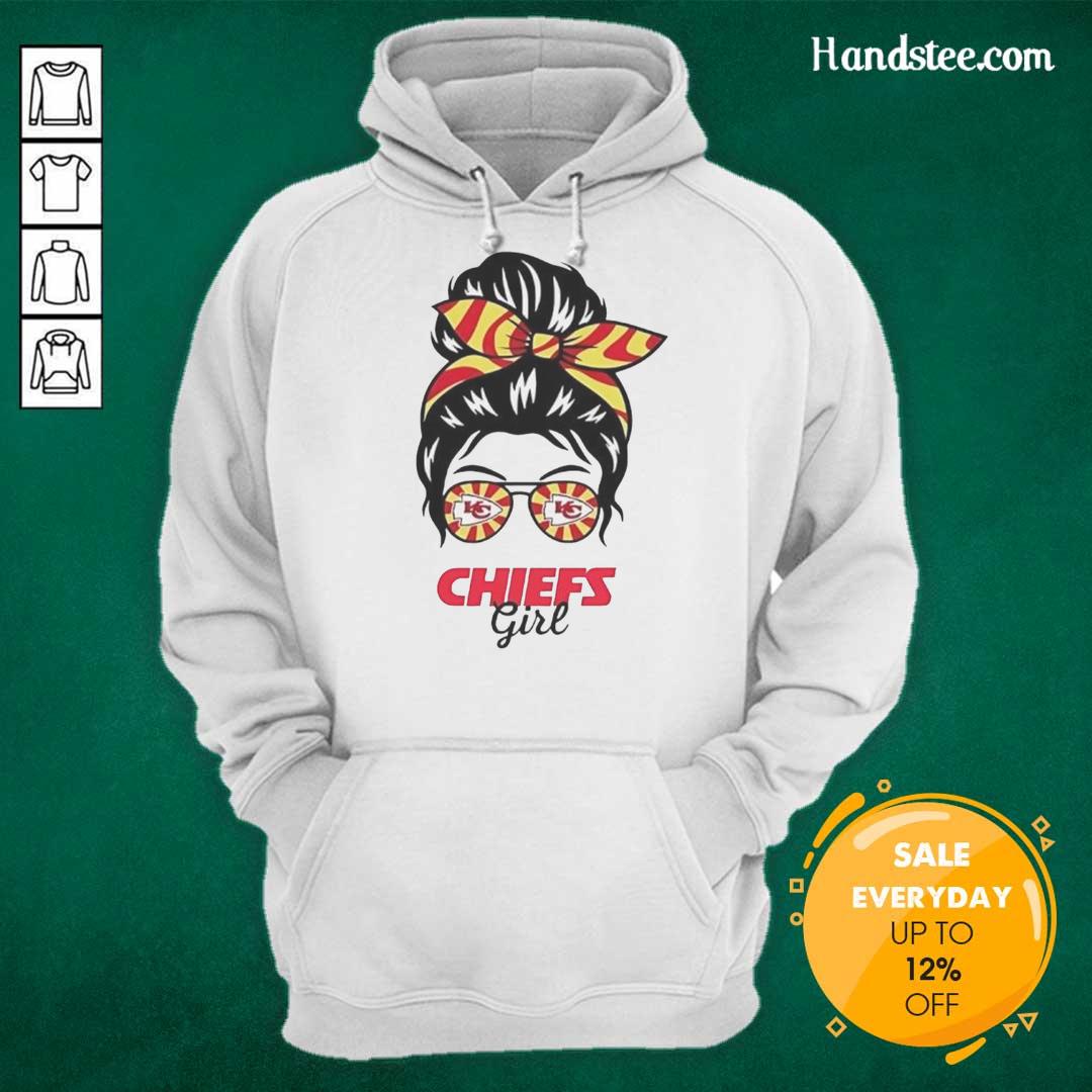 Cheerful Kansas City Chiefs girl in a messy bun, glasses, and hoodie, showcasing team spirit and style.