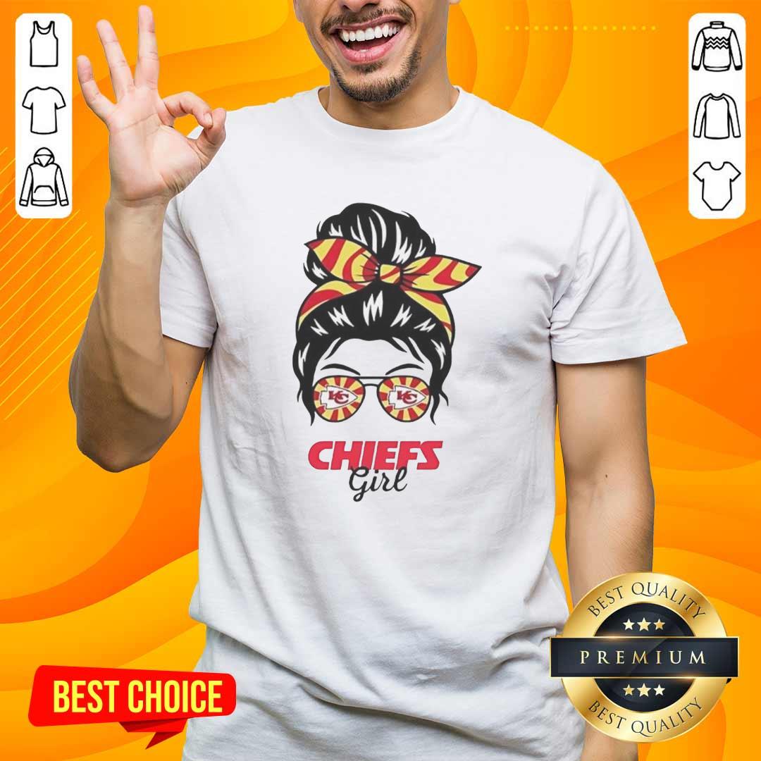 Alt Text: Girl wearing a Kansas City Chiefs t-shirt with a messy bun and glasses, showcasing team spirit and style.