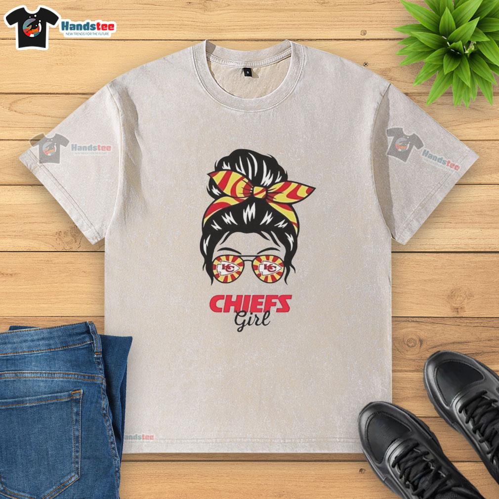 Girl in messy bun and glasses wearing a washed Kansas City Chiefs t-shirt, showcasing team spirit and casual style.
