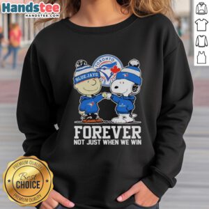 Charlie Brown fist pump in Toronto Blue Jays sweatshirt, celebrating fandom with Snoopy. Cute sports apparel for fans.