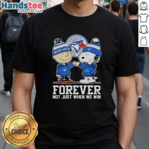 Alt Text: Cute Charlie Brown fist pump with Snoopy wearing Toronto Blue Jays Forever shirt, celebrating team spirit.