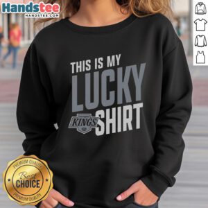Person wearing a lucky sweatshirt while cheering for the Los Angeles Kings at a hockey game in vibrant colors.