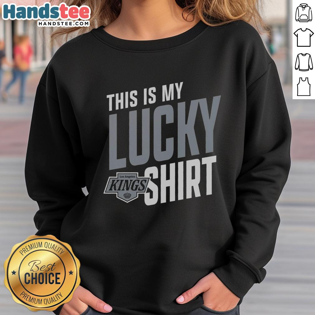 Person wearing a lucky sweatshirt while cheering for the Los Angeles Kings at a hockey game in vibrant colors.