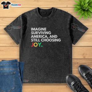Alt Text: Pretty Imagine Surviving America and Still Choosing Joy washed t-shirt in soft cotton, featuring a vibrant graphic design.