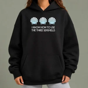 Original I Know How To Use The Three Seashells Hoodie in black, front view with kangaroo pocket and drawstring hood
